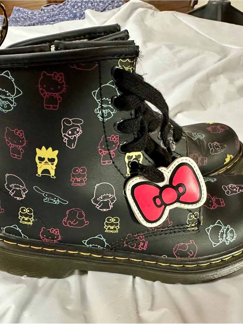 Dr. Martens Kids Black Boots with Multicolor Sanrio Print and Pink Bow Charm